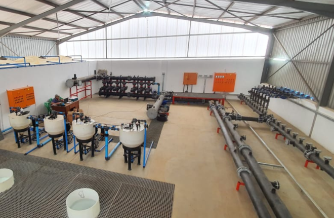 Interior of a pump house showcasing installed pipes, pumps, and fittings