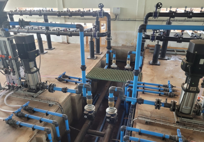 Interior of a pump house showcasing installed pipes, pumps, and fittings